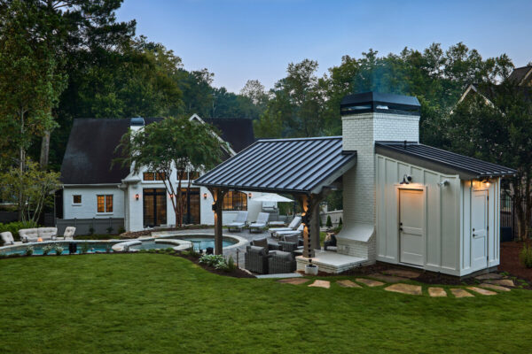 Backyard oasis with a pavilion, swimming pool, and lush landscaping.